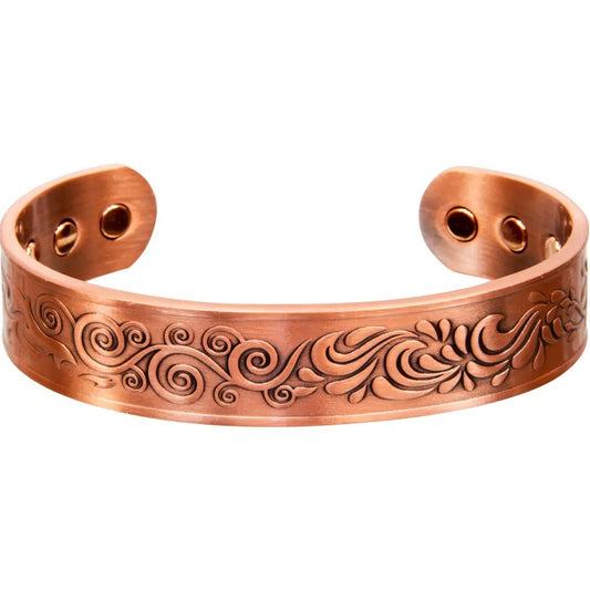 Copper bracelet with intricate designs on a white background