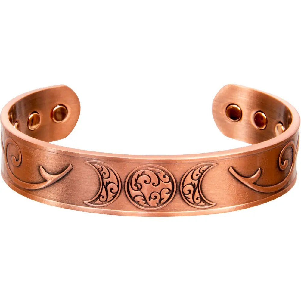 Copper bracelet with engraved designs on a white background