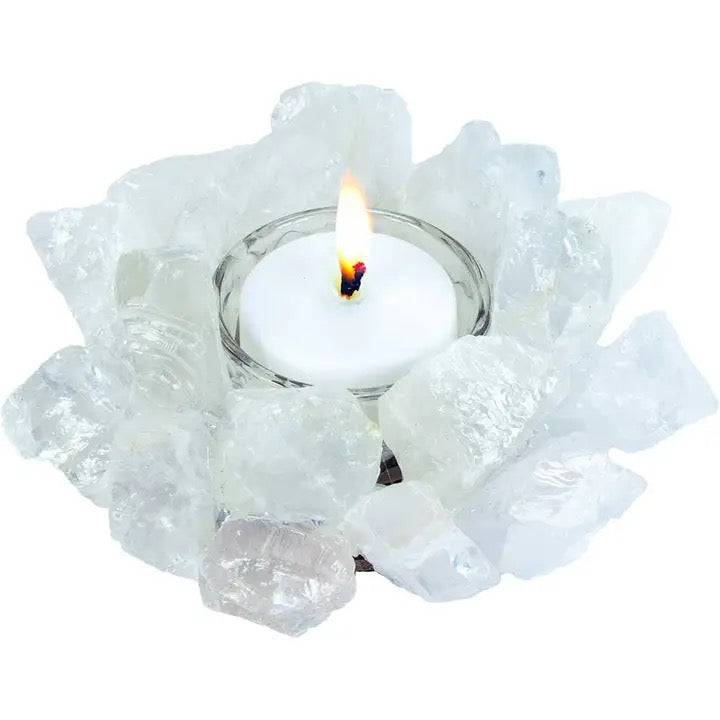 Candle holder with a lit candle surrounded by clear crystals on a white background