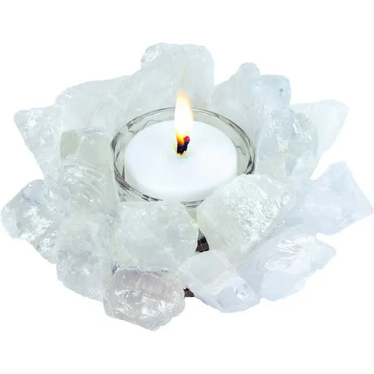 Candle holder with a lit candle surrounded by clear crystals on a white background