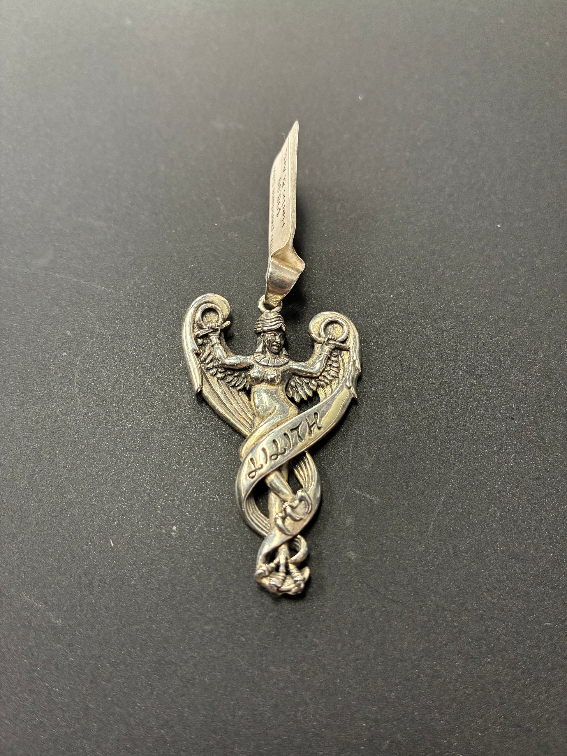 Silver pendant depicting Lilith with feathers and clawed feet.