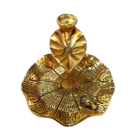 Decorative gold shell-shaped candle holder on a white background