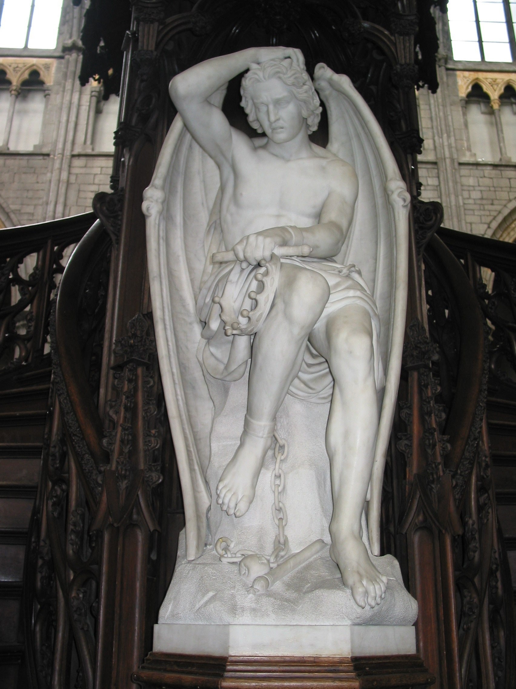 Statue of a winged figure in a cathedral setting