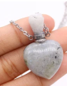 Heart-shaped silver pendant with a white stone on a chain