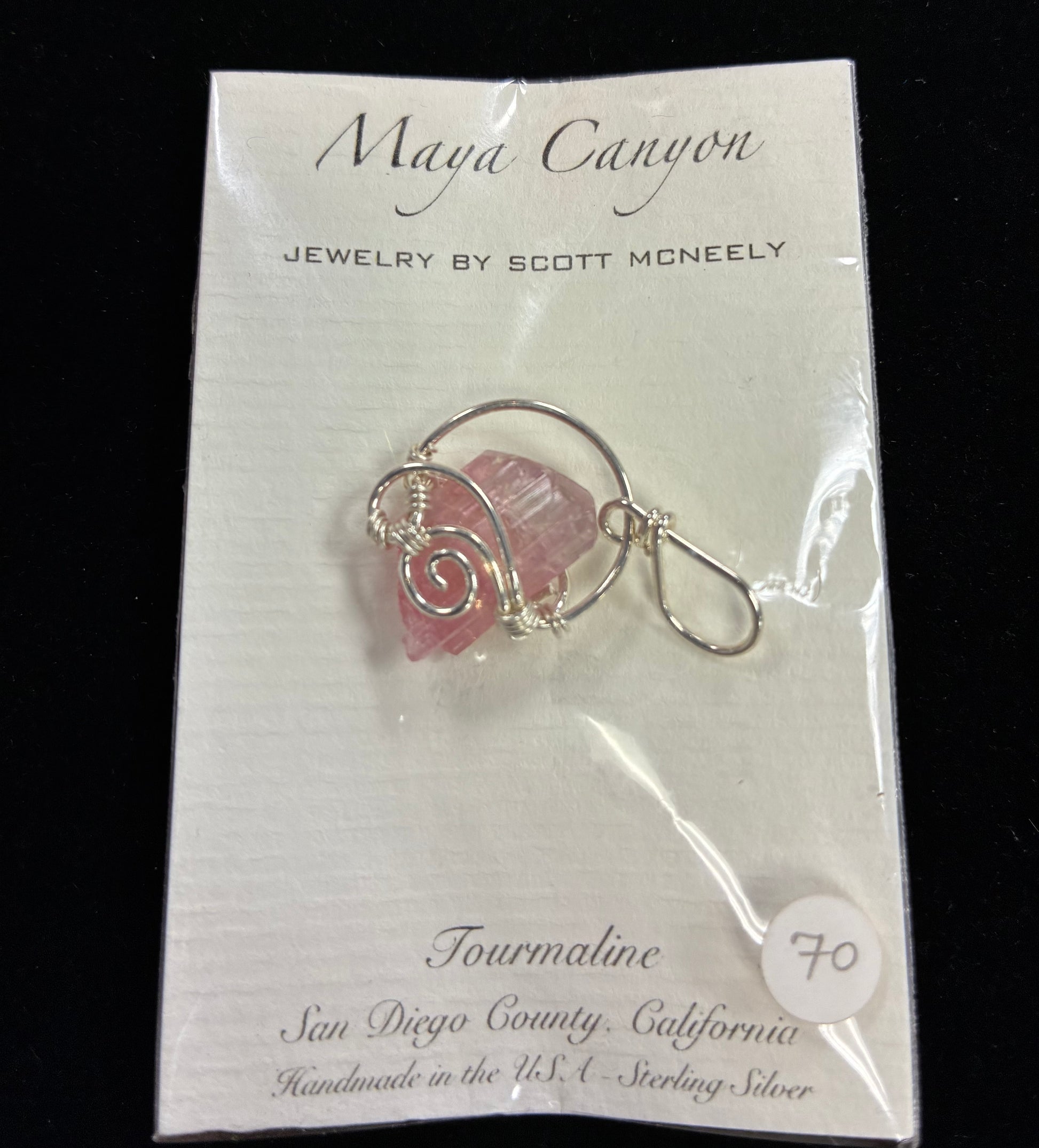 Pink Tourmaline stone wrapped in sterling silver in a pendant form.
