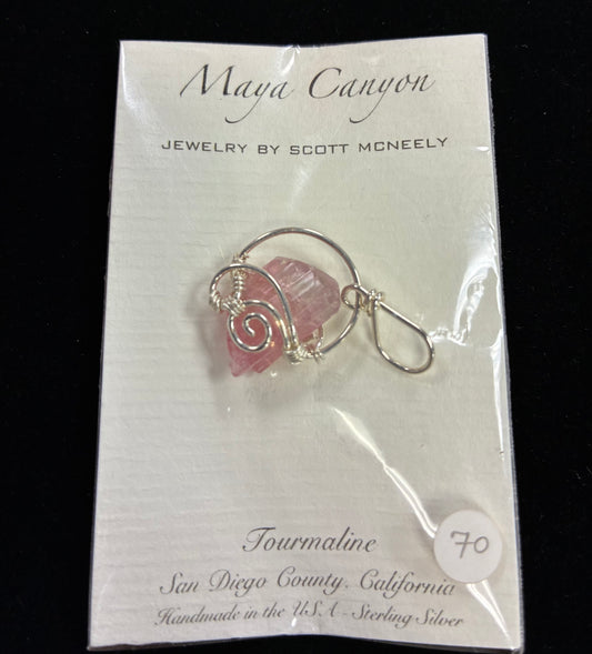Pink Tourmaline stone wrapped in sterling silver in a pendant form.
