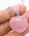 Pink bottle with a silver chain on a white background