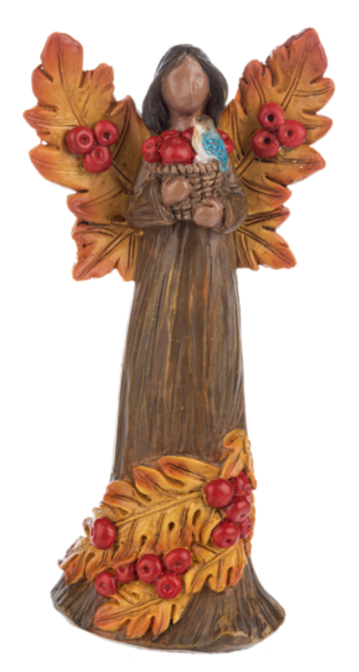 Decorative angel figurine with autumn leaves and berries on a white background