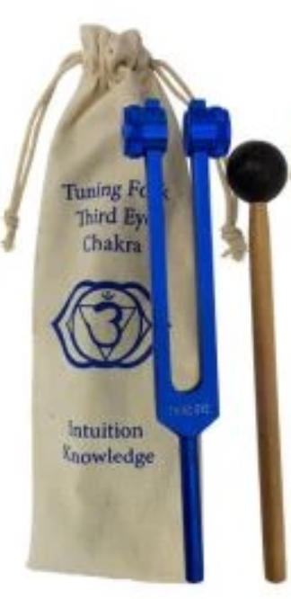 Blue tuning fork with a mallet on a beige drawstring bag labeled 'Tuning Fork Third Eye Chakra Intuition Knowledge'.