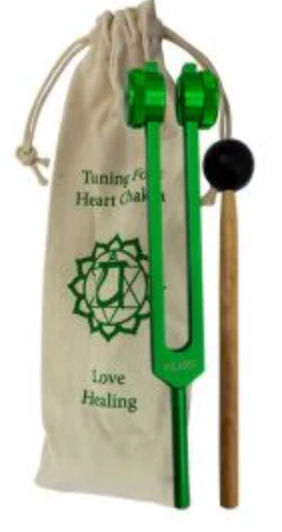 Green tuning fork with black handle on a white background