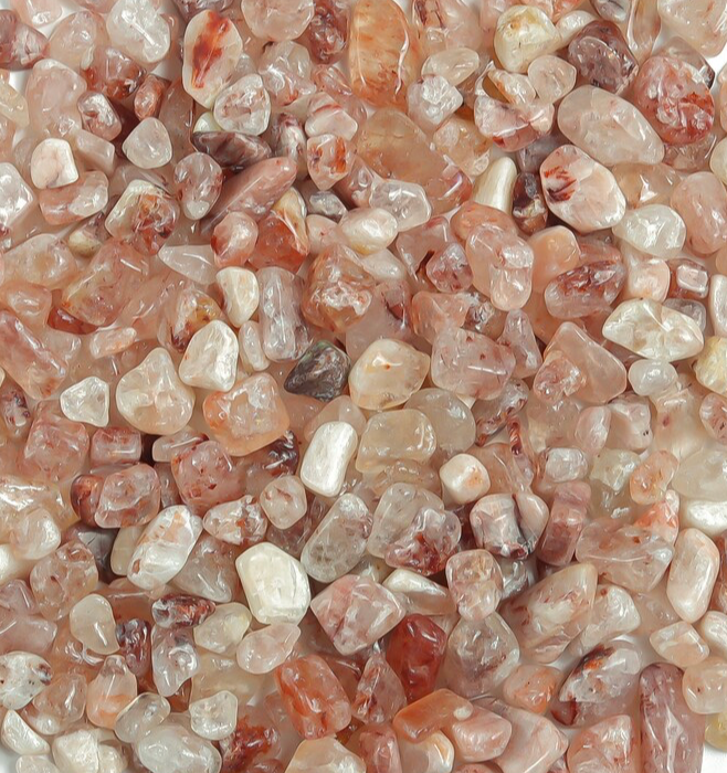 Close-up of small, multicolored stones with a pinkish hue.