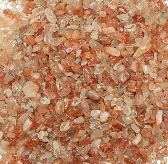 Close-up of small pebbles with a pinkish-orange hue