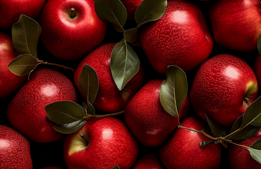 Close-up of red apples with green leaves on a dark background