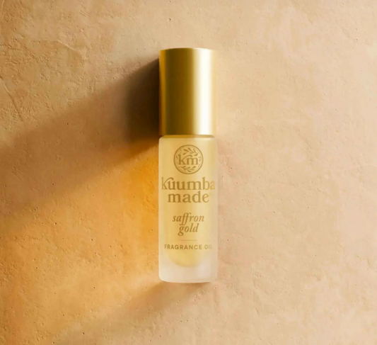 KÜlumba Made saffron gold fragrance oil bottle on a beige background