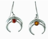 Silver earrings with crescent moon design and red gemstones on a white background