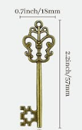 An ornate antique-style metal key shown vertically with dimension labels indicating 0.9 inches (18mm) at the top and 2.