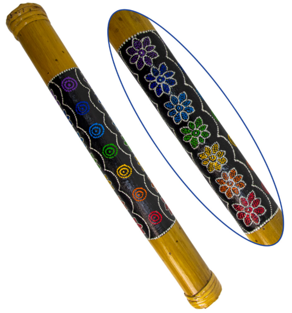 A close-up of a wooden rain stick with a black painted body featuring colorful floral and circular patterns, shown alongside a zoomed-in detail of the decoration.