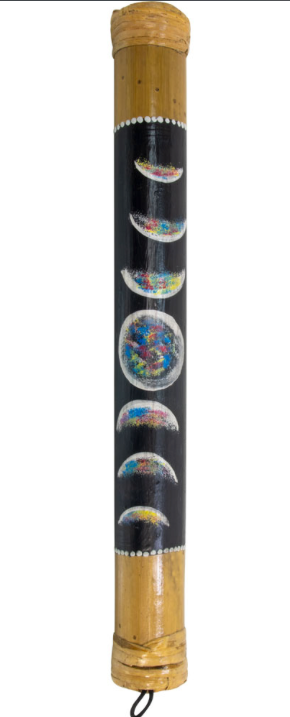 A handcrafted bamboo drum with a black body decorated with colorful moon phase illustrations and white painted dots, shown against a plain white background.