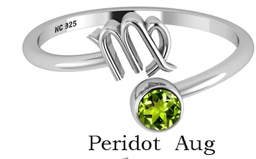 Silver ring with zodiac symbol and peridot stone on a white background