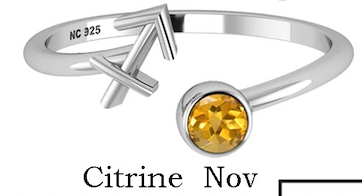 Silver ring with a yellow gemstone and 'NC 925' marking on a white background.