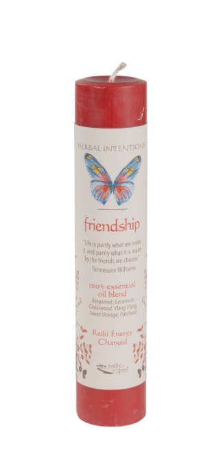 Red candle with a butterfly design and text on a white background