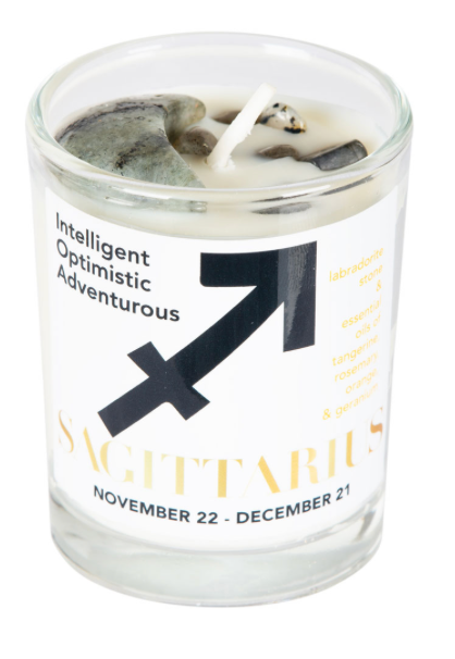Candle in a glass jar with a Sagittarius zodiac design and text on a white background