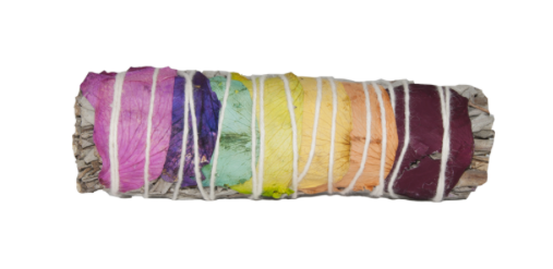 A rainbow-colored smudge bundle wrapped in white string, made from layered dried flower petals in pink, purple, blue, green, yellow, orange, and red, set against a plain white background.