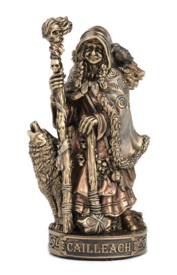 Bronze statue of a figure with a staff and wolf, labeled 'Cailleach', on a white background