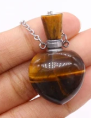 Tiger's eye stone in a glass bottle with a chain