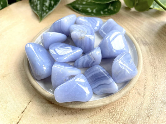 Blue, white, and gray tumbled stones with striations.