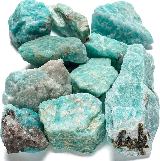 greenish blue raw stones , some have black smoky quartz inclusions and yellow and white inclusions