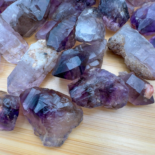 raw pieces of purple stone points 