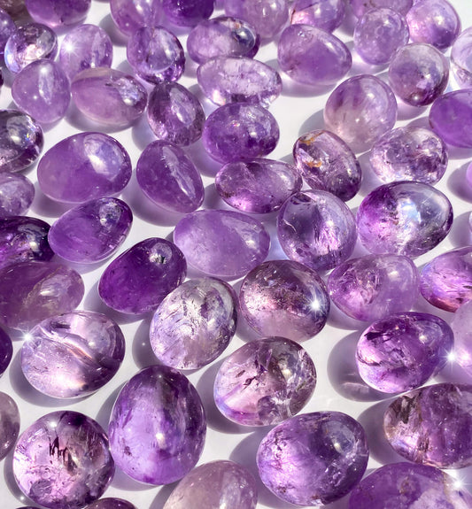 tumbled purple amethyst pieces, all around 1-2 inches wide