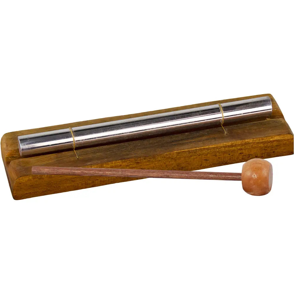 silvery metal rod on wooden base  with mallet