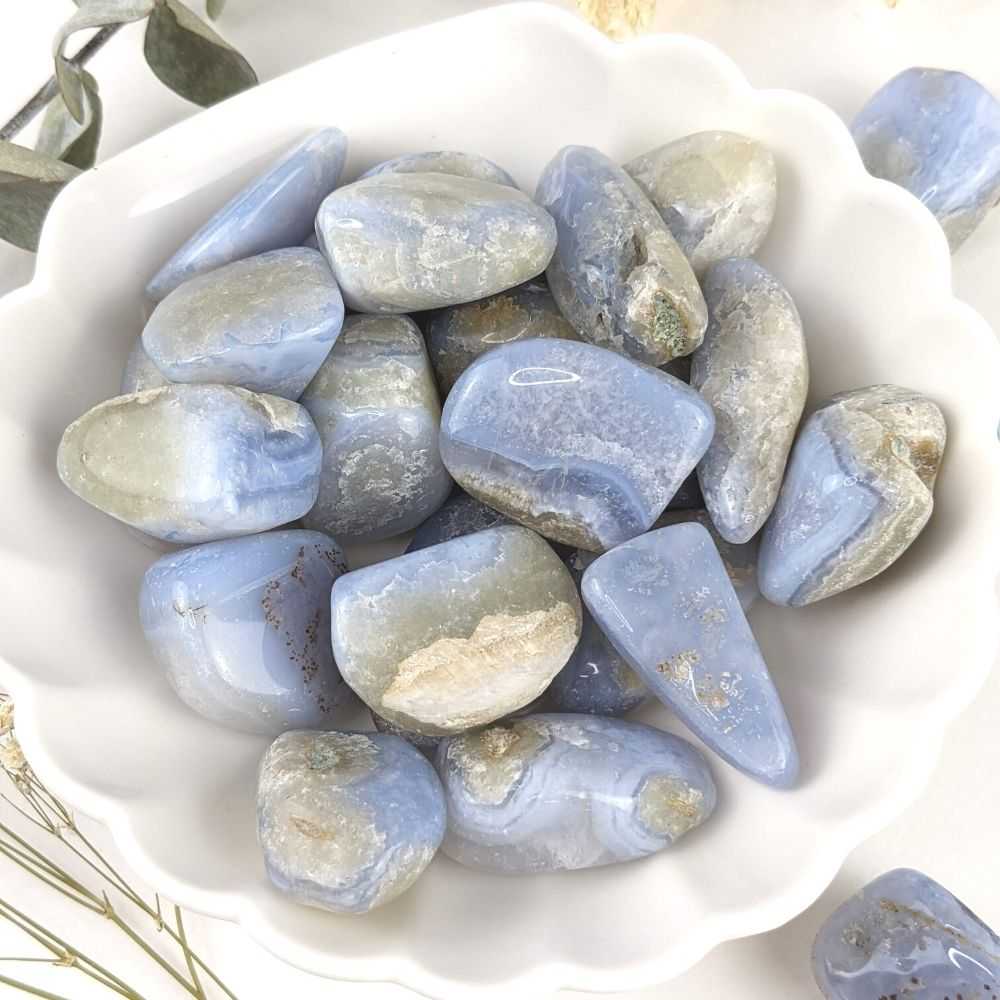 blue, white, and gray tumbled stones with striations and quartz spots