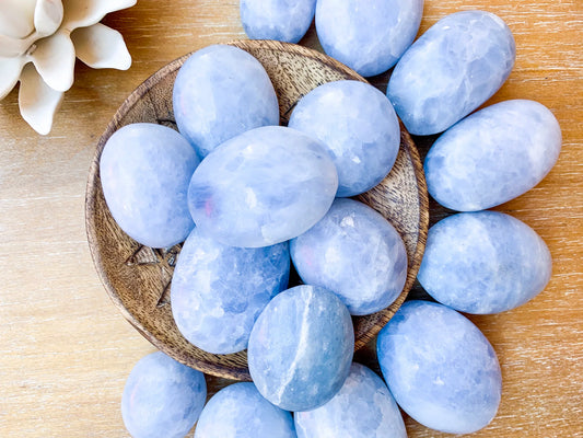 Light blue palm sized stones with a shiny waxy finish