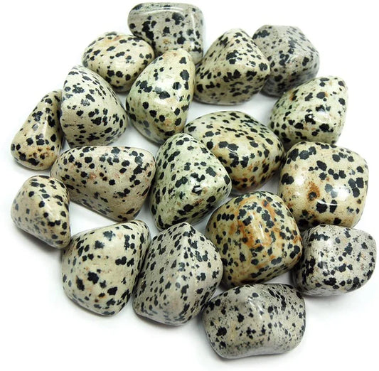 tumbled smooth, white and cream colored stones with black and brown spots