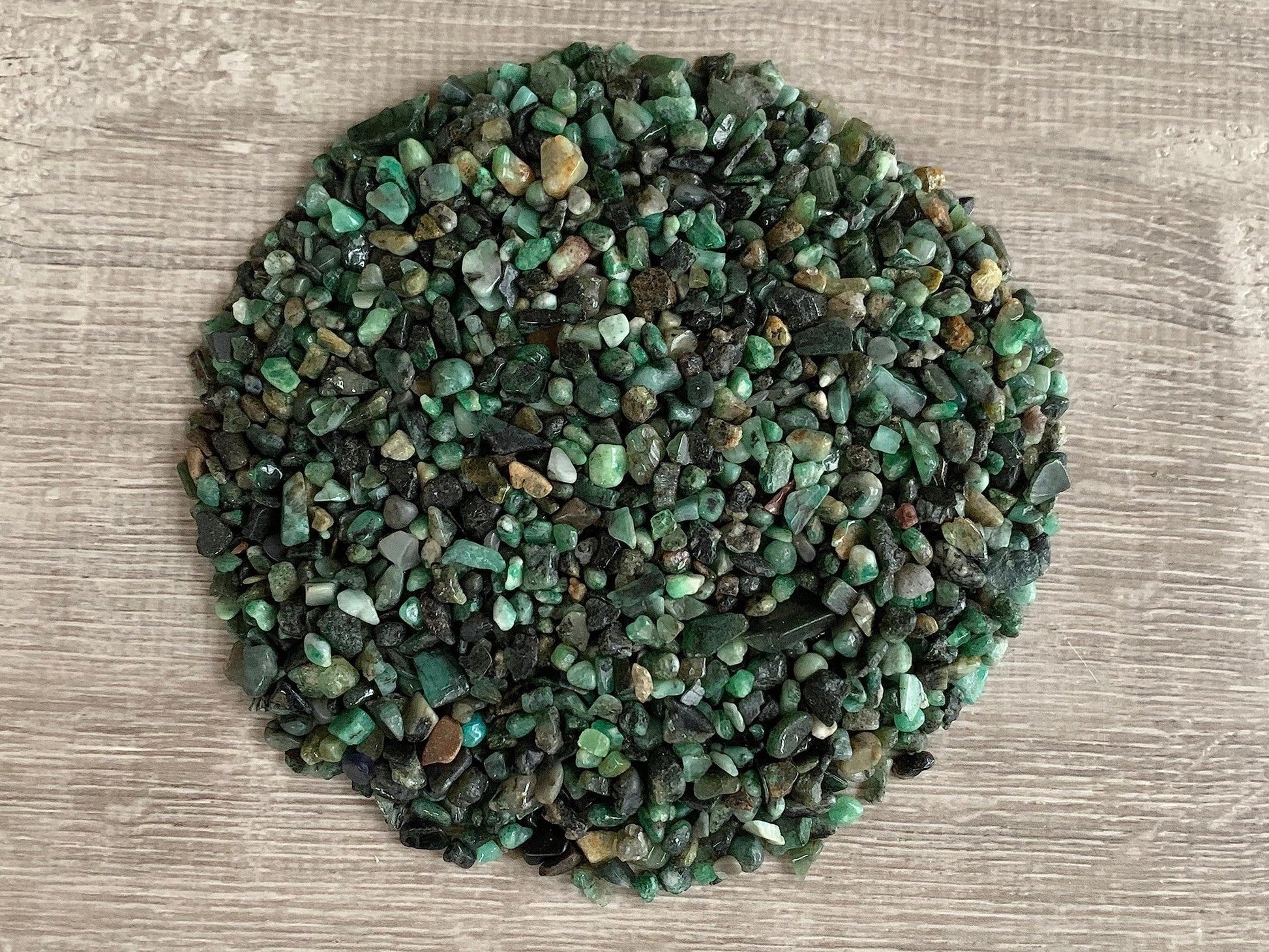 free form rough but tumbled tiny stone chips in varying shades of grey, green, and turquoise