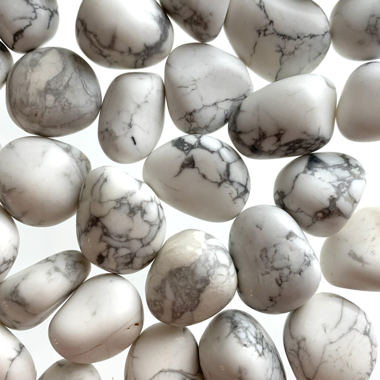 white smooth tumbled stones with black and grey crackled pattern