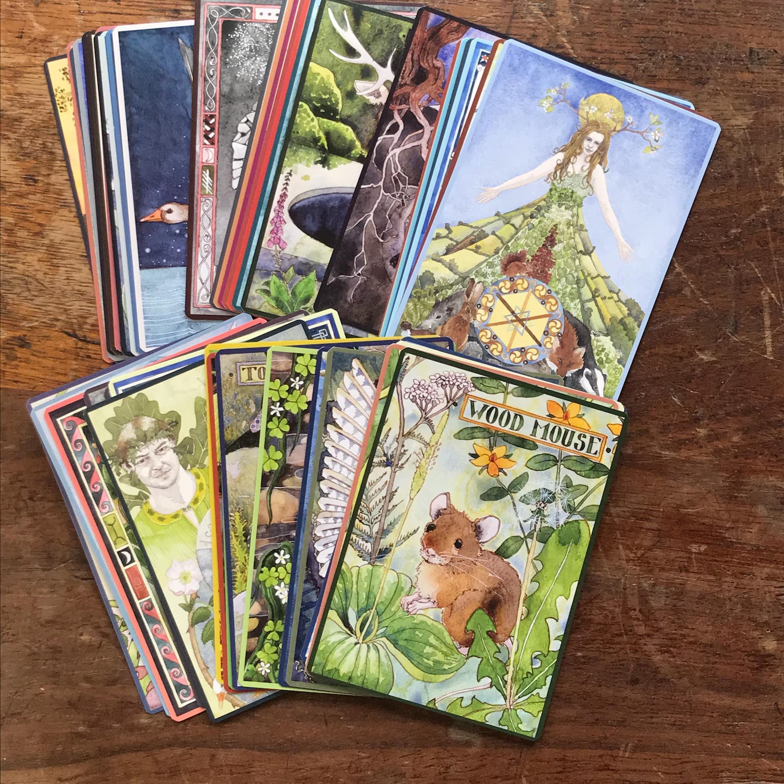 Collection of tarot cards on a wooden surface