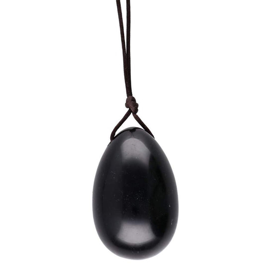 Black egg-shaped pendant on a cord against a white background