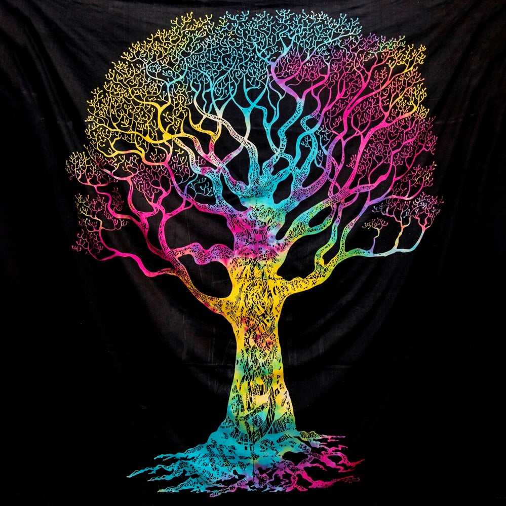 A vibrant, multicolored tree of life tapestry or wall hanging displayed against a black fabric backdrop. The tree features a gradient of neon colors including yellow, green, blue, cyan, and pink, with intricate branching details and roots on a black background.