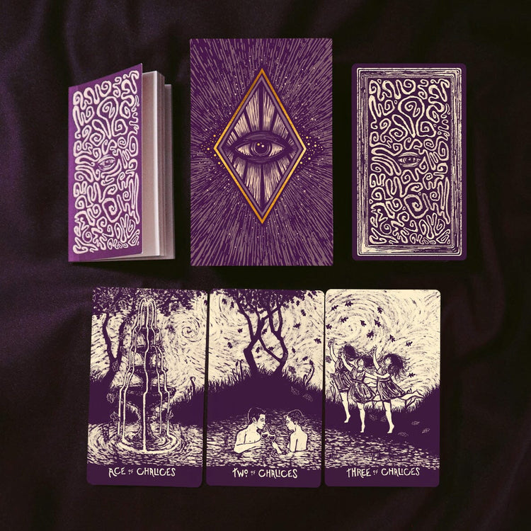 Set of tarot cards with intricate designs on a dark background