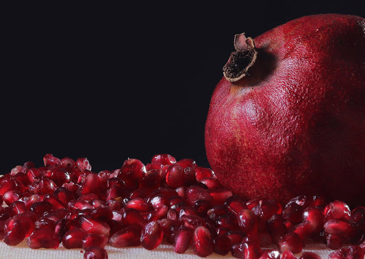 Pomegranate with seeds on a dark background